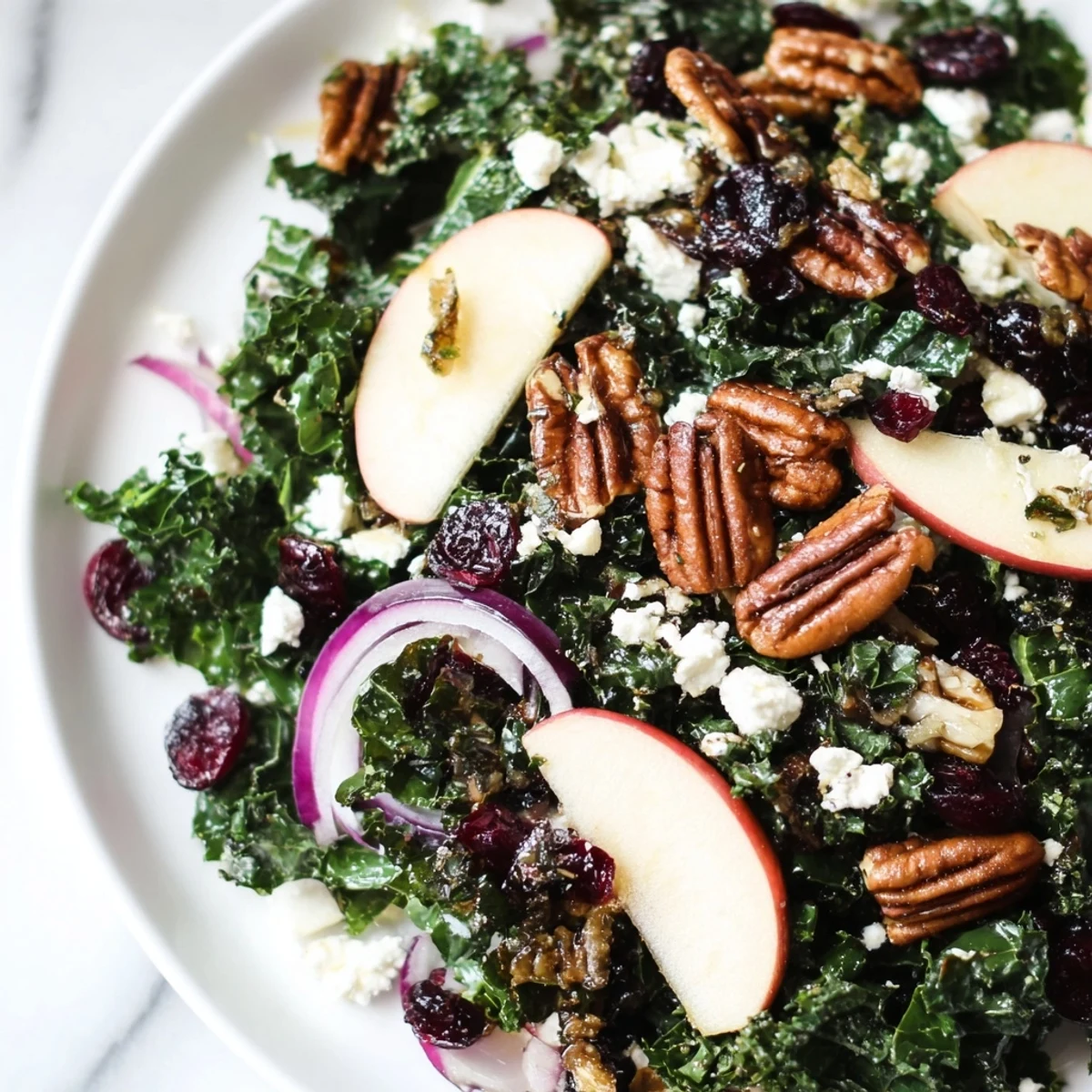 Hearty Winter Kale Salad featuring toasted pecans and dried cranberries, ready to serve for lunch.