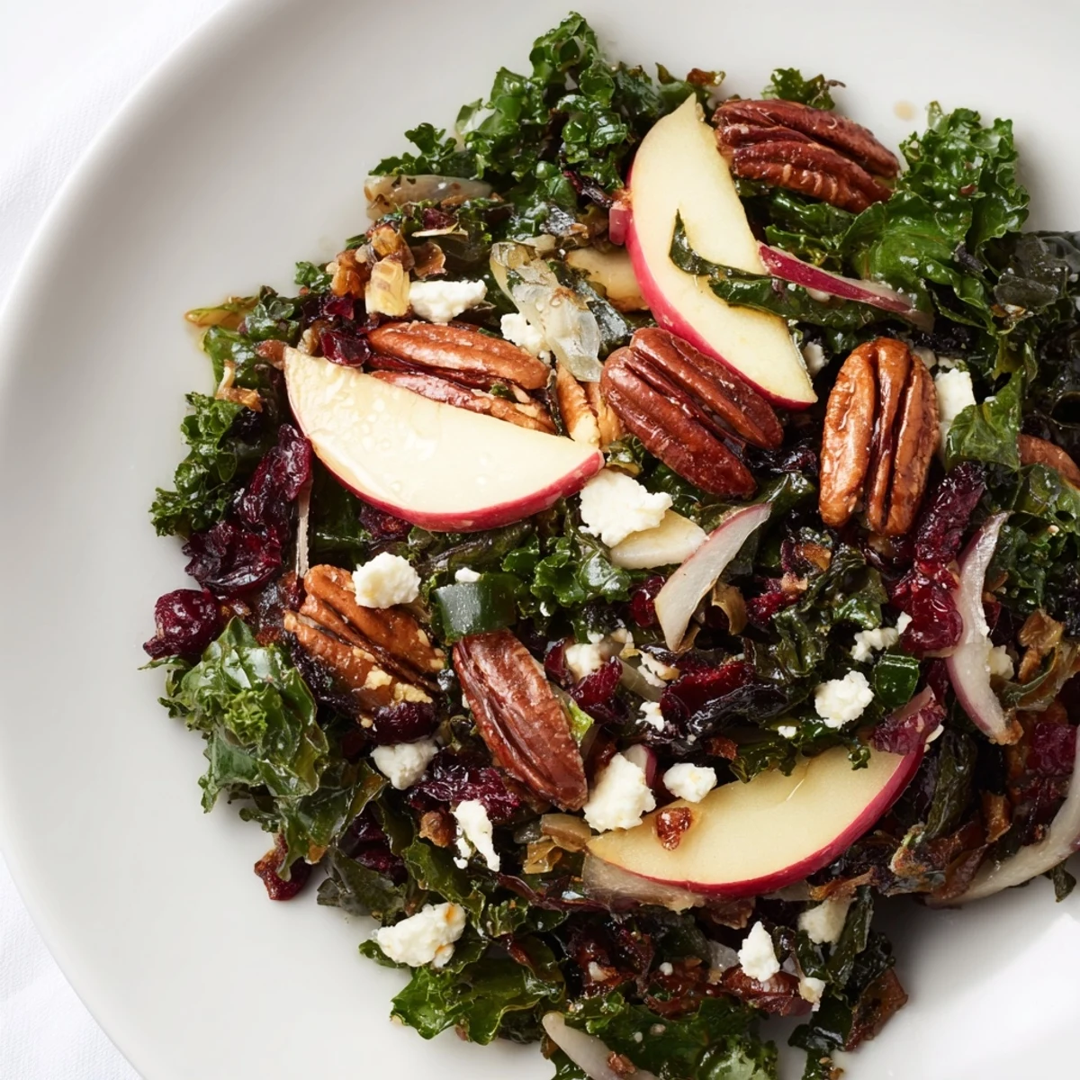 Close-up of a textured Winter Kale Salad, highlighting the crisp kale and maple-Dijon vinaigrette.