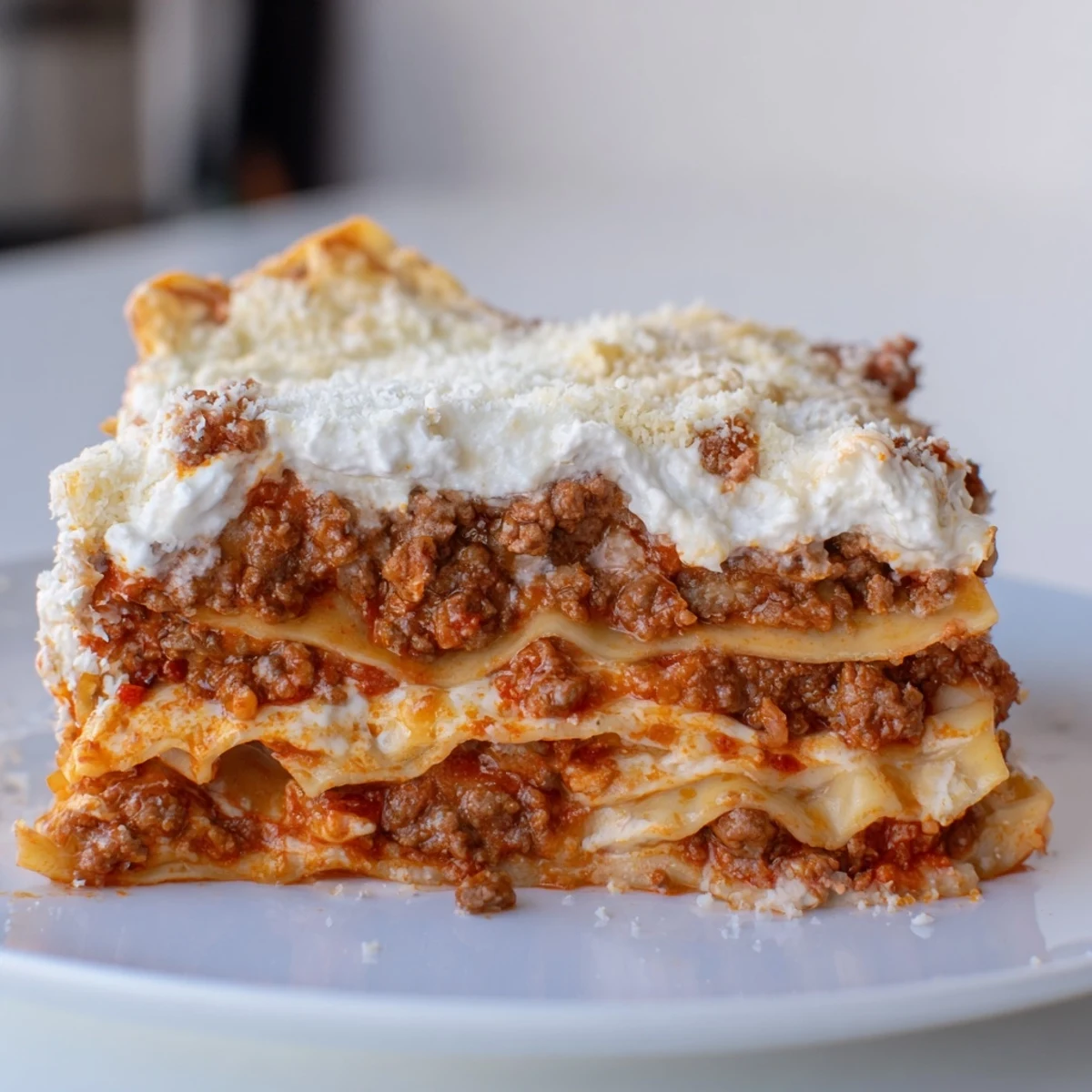 Freshly baked Classic Beef Lasagna with golden, bubbling mozzarella and Parmesan on top, served hot from the oven.