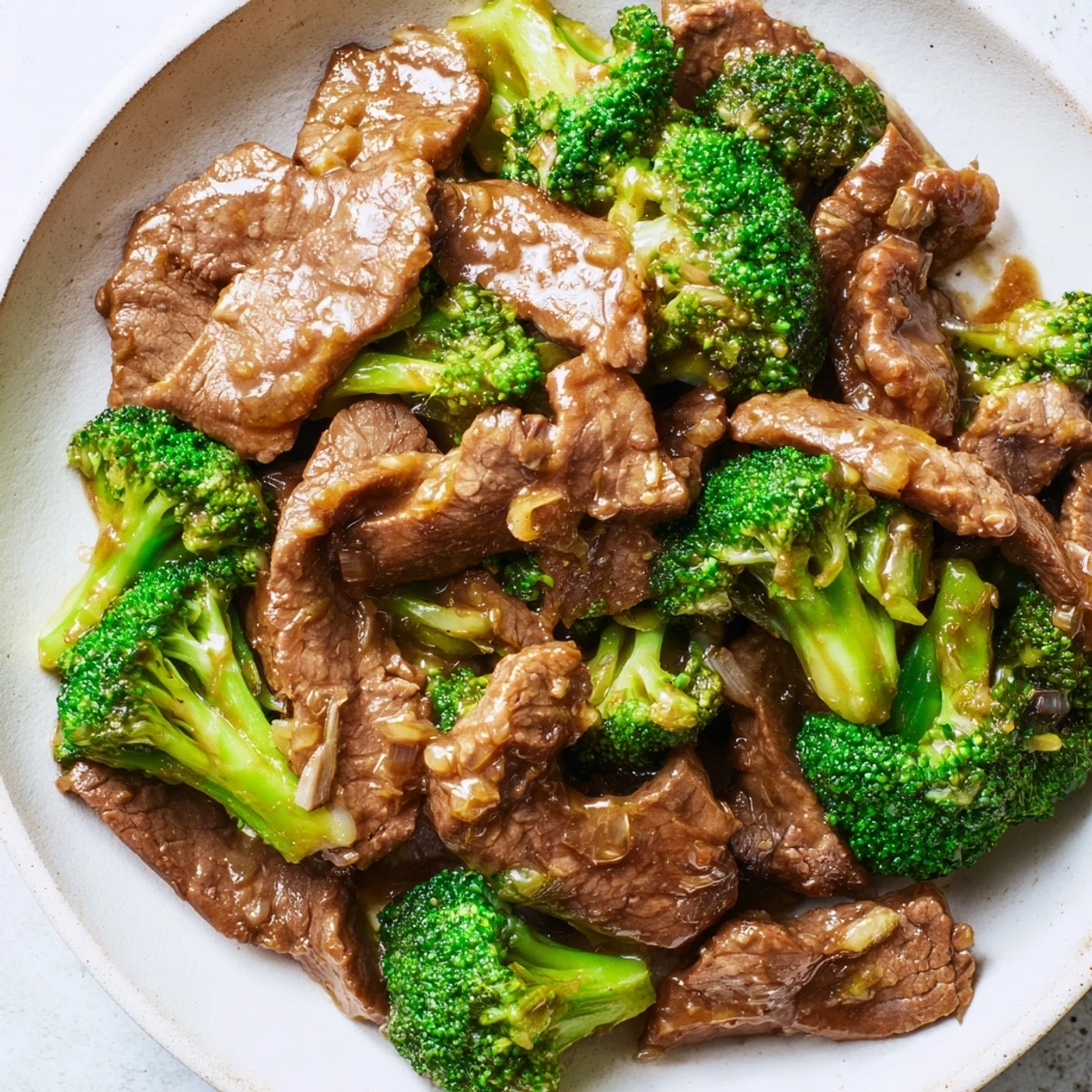 Tender beef and crisp broccoli in a glossy oyster sauce, a classic Beef and Broccoli Stir Fry served over fluffy white rice.