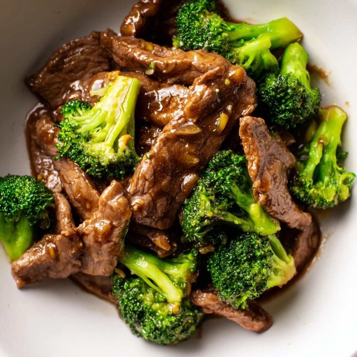 Easy Beef and Broccoli Stir Fry with Oyster Sauce plated for a quick weeknight dinner, garnished with sesame seeds and served with chopsticks.
