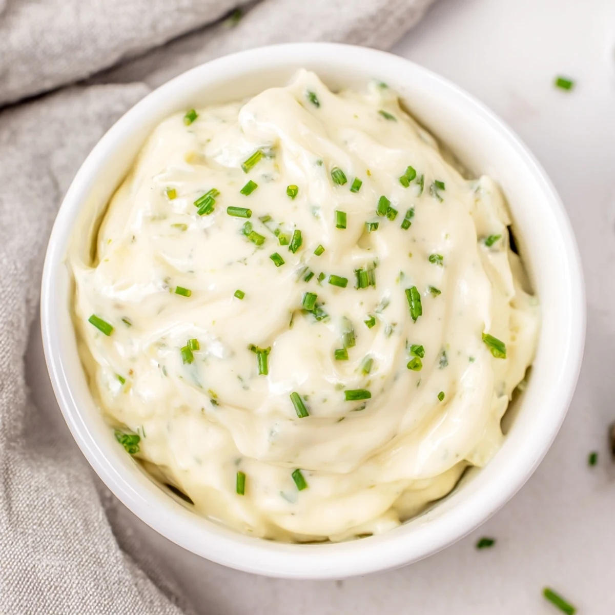 Fresh, creamy Creamy Salad Dressing in a glass jar with herbs, ready to drizzle over a crisp green salad. 