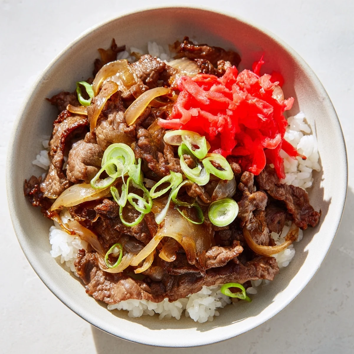 Served hot in a ceramic bowl, this savory Beef Bowl with Rice makes a perfect weeknight meal.