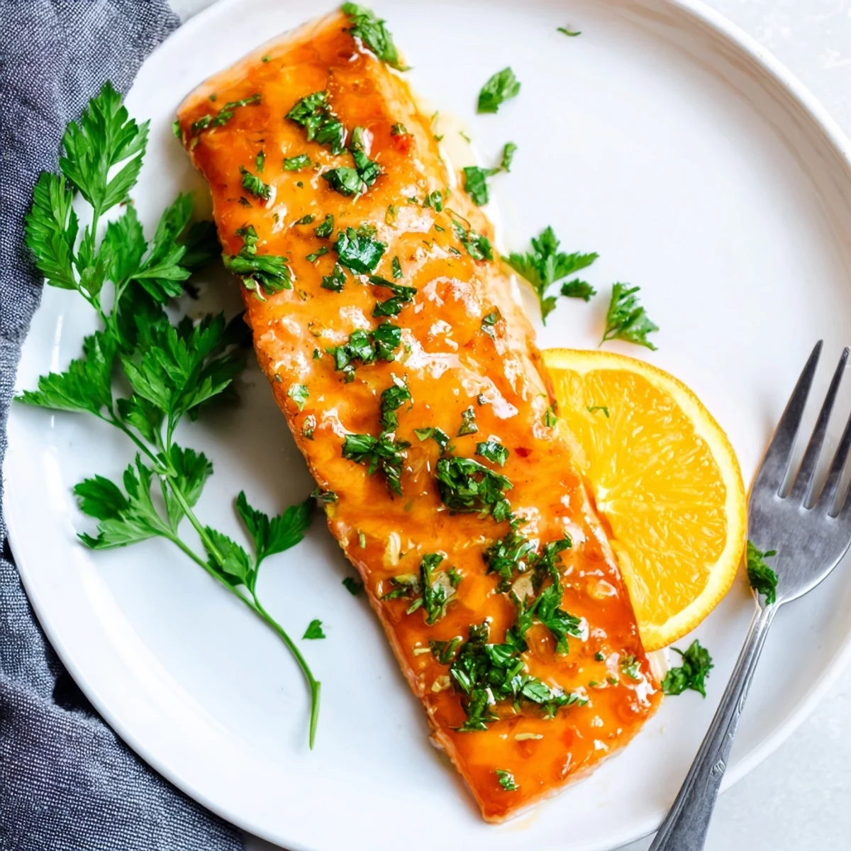 Close-up of glazed salmon fillets, showcasing moist orange-glazed fish perfect for an easy weeknight meal.