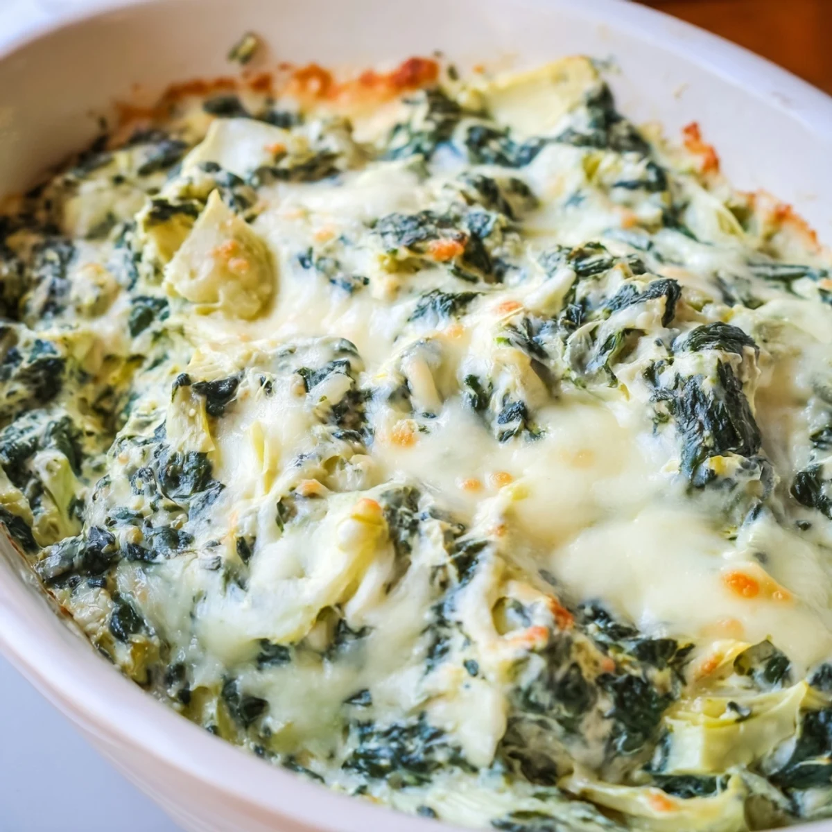 Creamy spinach and artichoke dip baked until bubbly, with a side of crisp baguette slices perfect for scooping up the velvety blend.