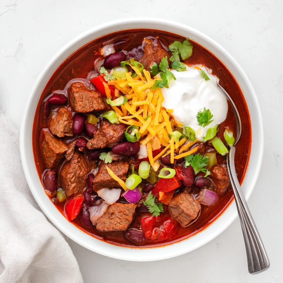 Slow Cooker Beef Chili with Beans simmering in a slow cooker, featuring tender beef chunks and colorful kidney beans.  