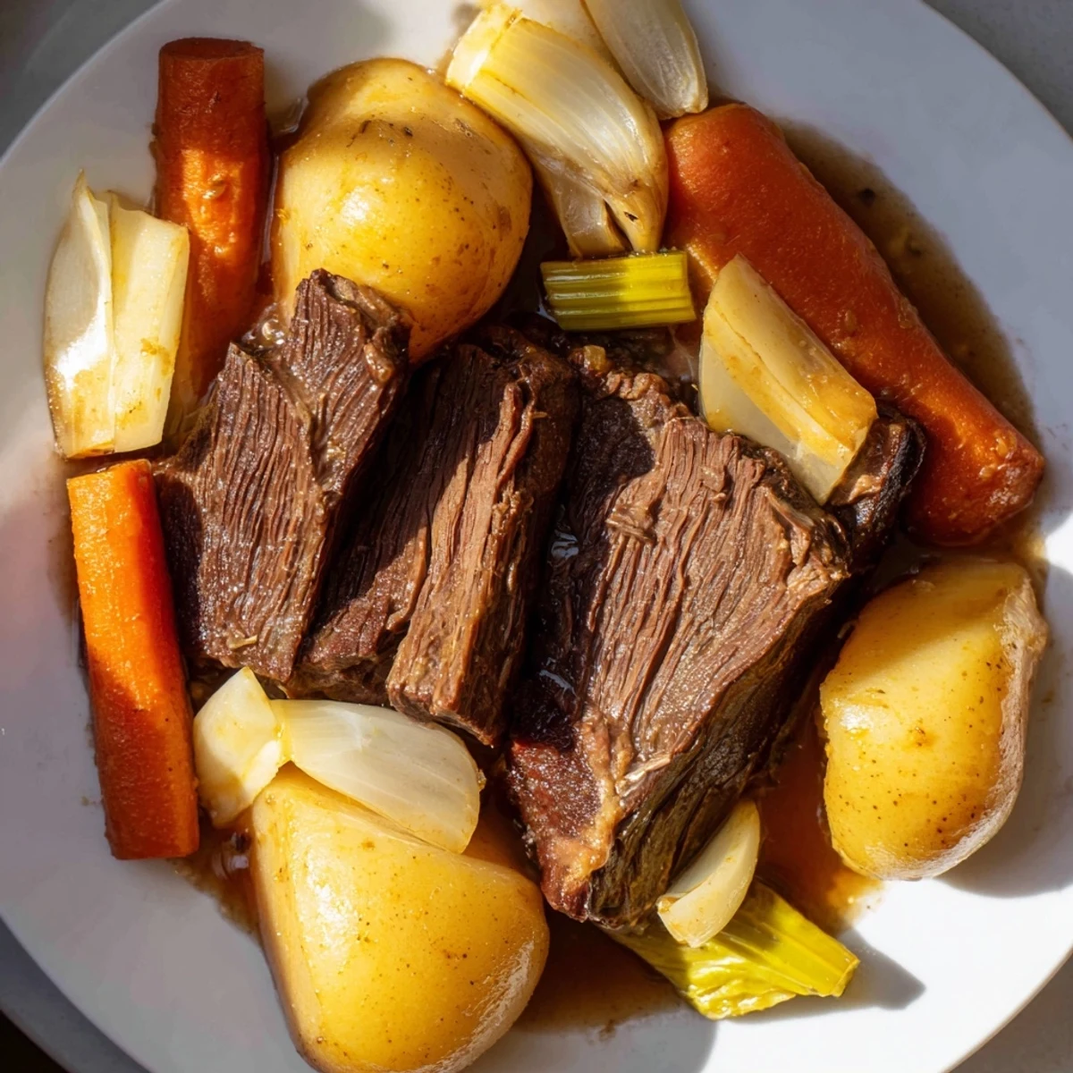 Close-up of Slow Cooker Beef Pot Roast with Root Vegetables, showcasing juicy shredded beef and glazed root vegetables in a savory, aromatic broth.