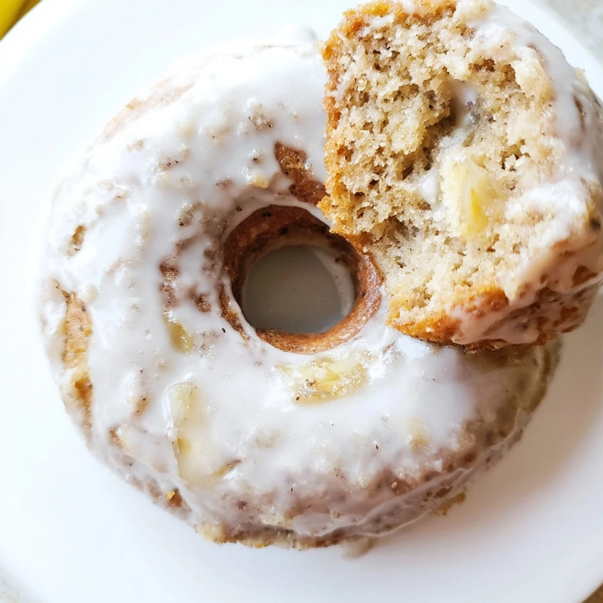 A close-up view of golden Baked Banana Bread Donuts on a wooden board, ready for breakfast or an afternoon treat.