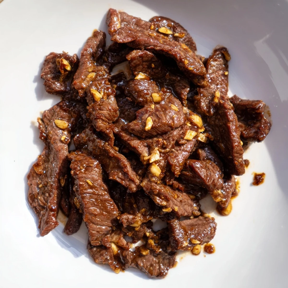 Tender beef slices glazed in savory-sweet sauce over steamed rice for Ultimate Slow Cooker Mongolian Beef.
