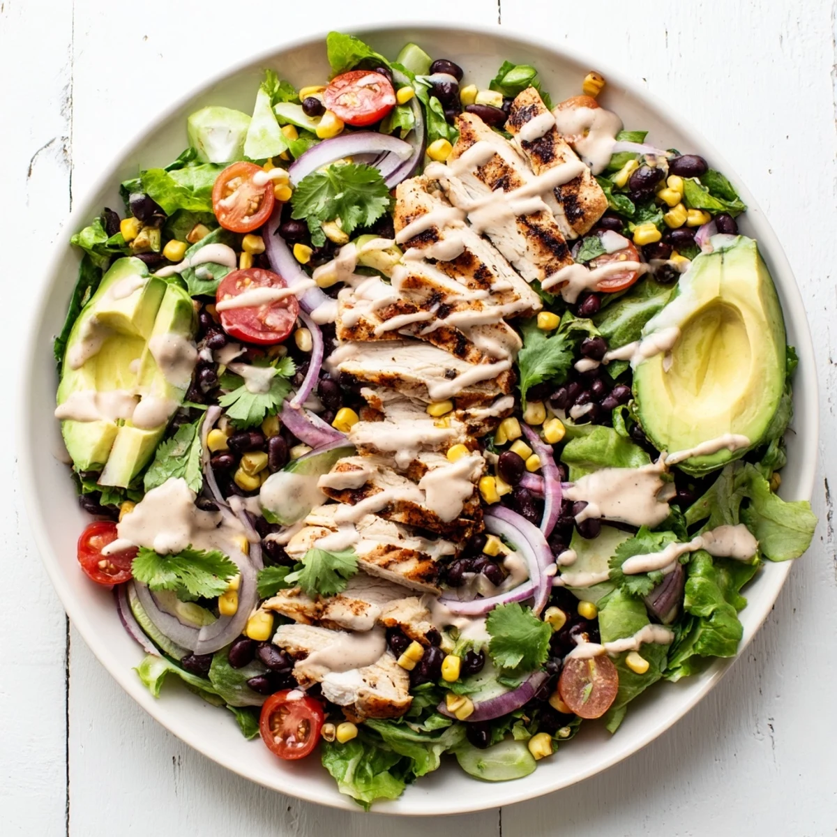 Vibrant Chipotle Lime Chicken Salad with smoky grilled chicken slices over crisp mixed greens, tomatoes, and creamy avocado.