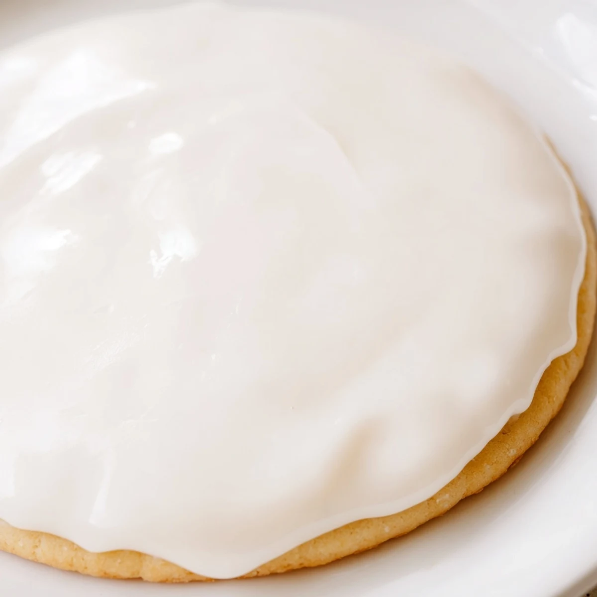 Sugar Cookie Icing in a small bowl with a whisk, ready for piping intricate designs onto cookies.  