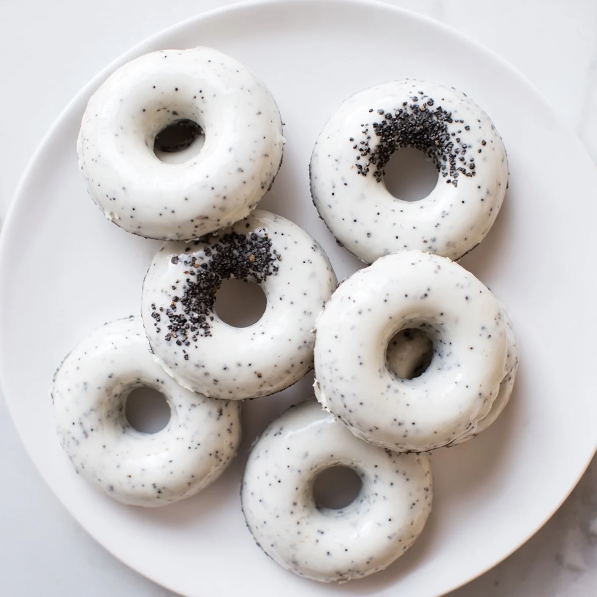 Gluten-free Black Sesame Mochi Donuts arranged on a cooling rack, perfect for a Japanese-inspired dessert or afternoon snack.