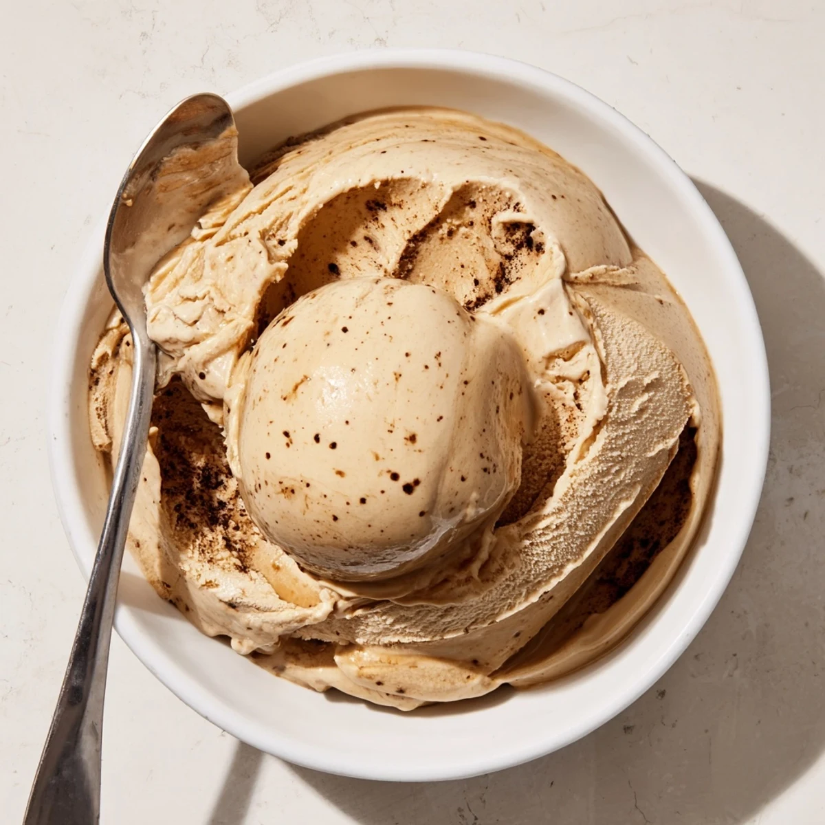 Vietnamese Coffee Ice Cream layered with crushed ice and a drizzle of condensed milk offers a cool, sweet finish.