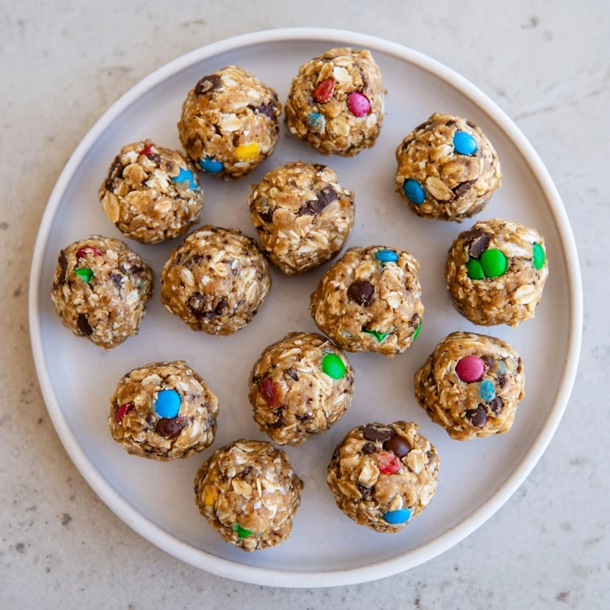Peanut butter Monster Cookie Protein Balls with oats and colorful M&Ms are a chewy, no-bake snack.