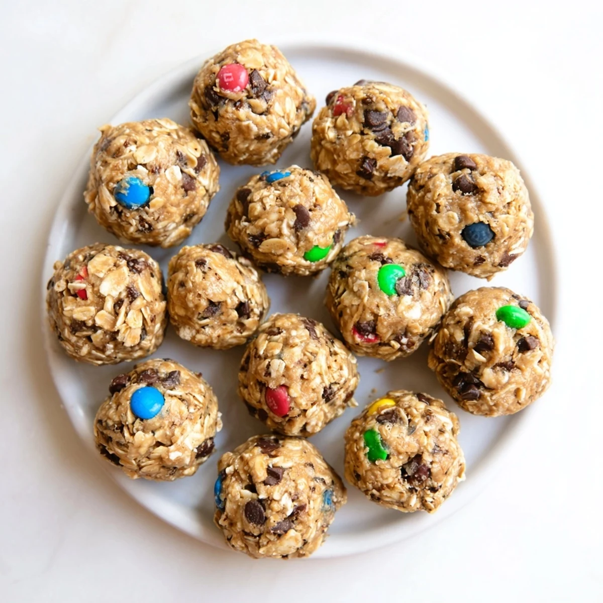 A close-up of golden Monster Cookie Protein Balls rolled in oats, perfect for a protein-packed treat.