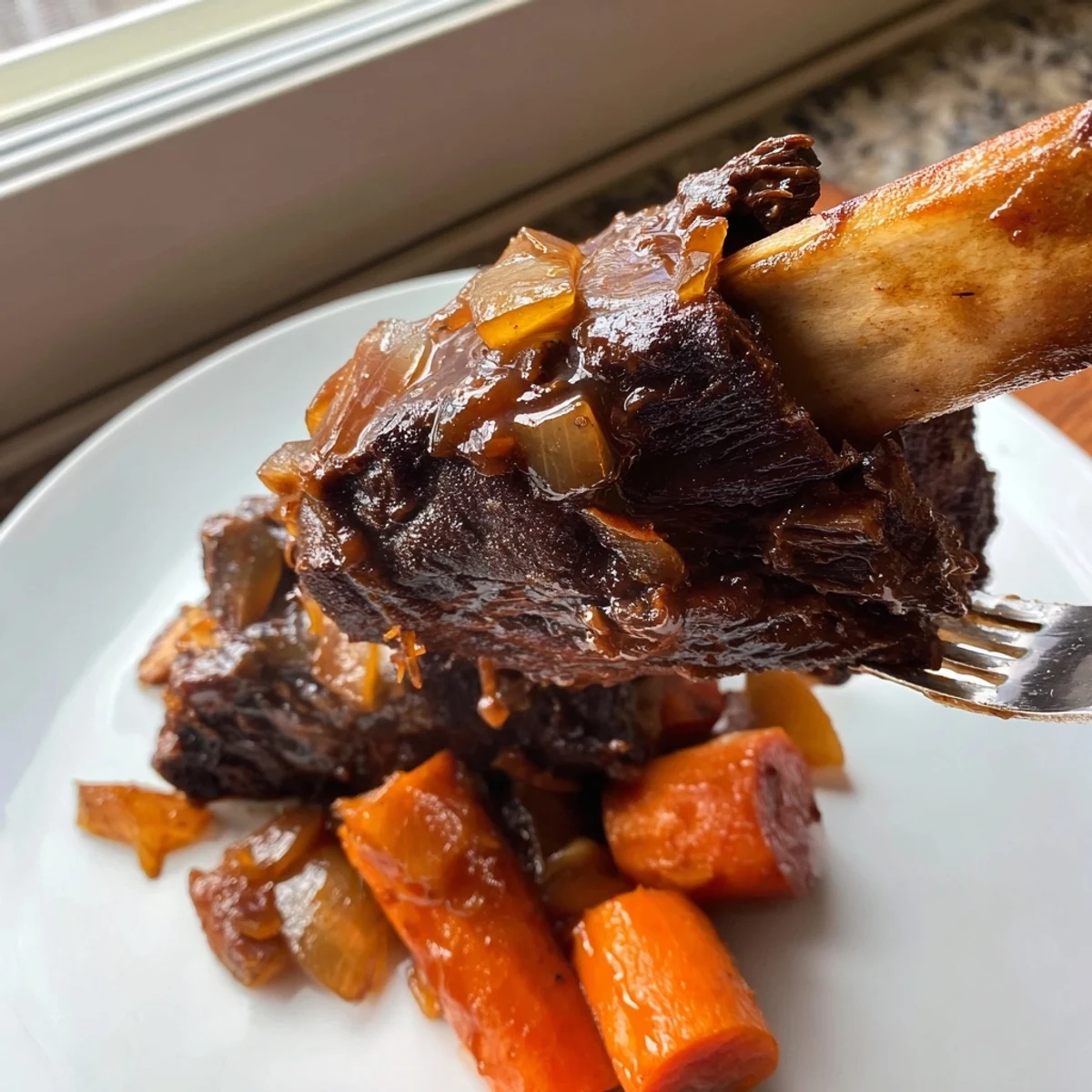Tender Maple Bourbon Glazed Short Ribs braised until fork-tender, paired with roasted root vegetables for a comforting meal.