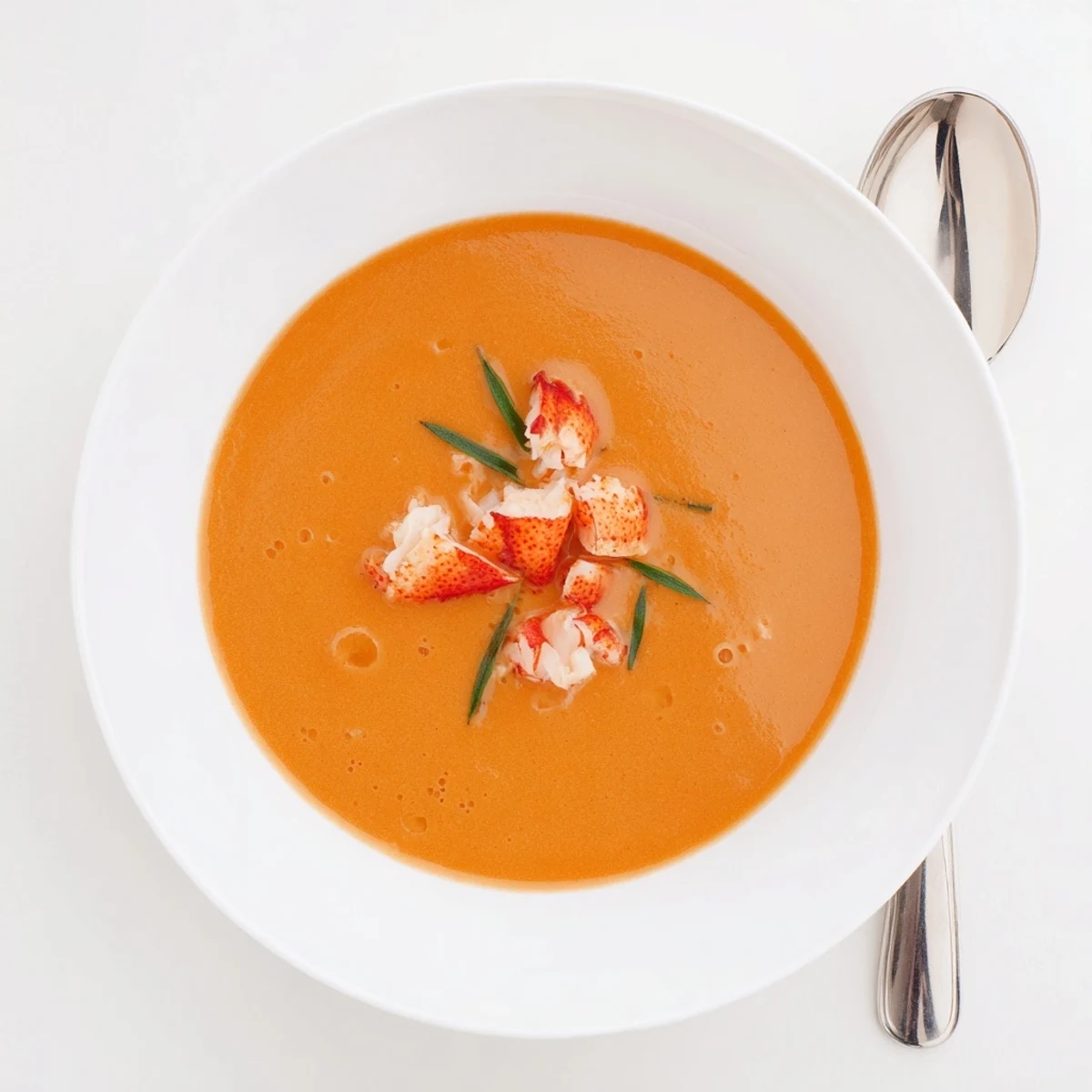 Velvety smooth Gordon Ramsay lobster bisque featuring tender lobster meat and elegant herb garnish