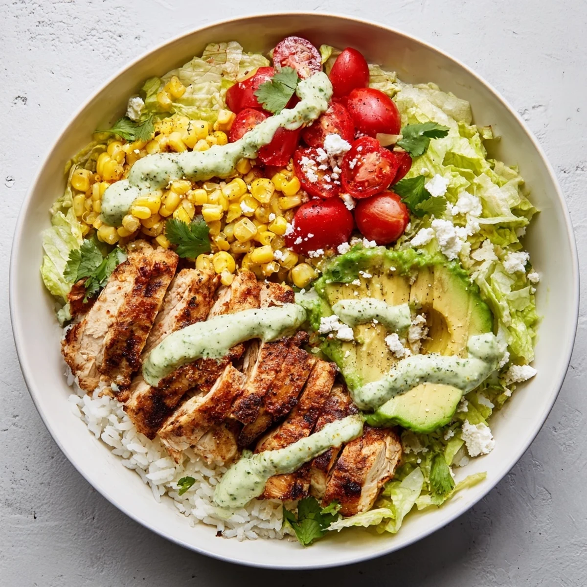 Vibrant Mexican-inspired tasty street corn chicken bowl with juicy seasoned chicken, roasted sweet corn, fresh avocado, and zesty lime crema