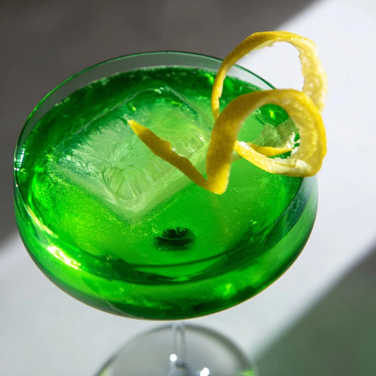 Vibrant Luck of the Irish cocktail showcasing whiskey base and citrus over ice cubes