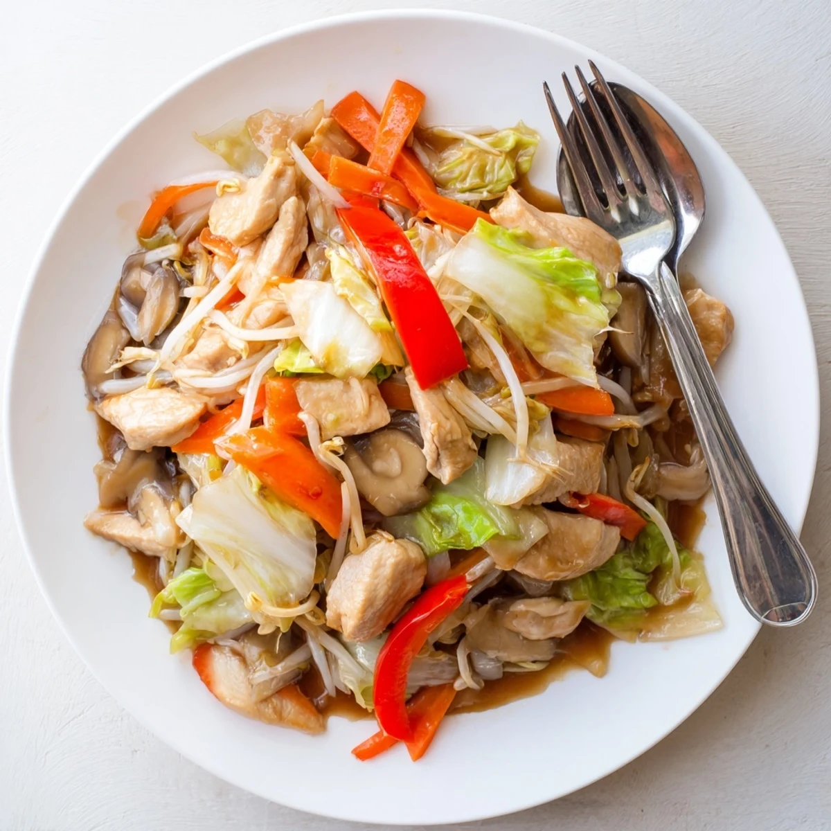 Steamy plate of homemade Chop Suey served over white rice with crunchy bean sprouts