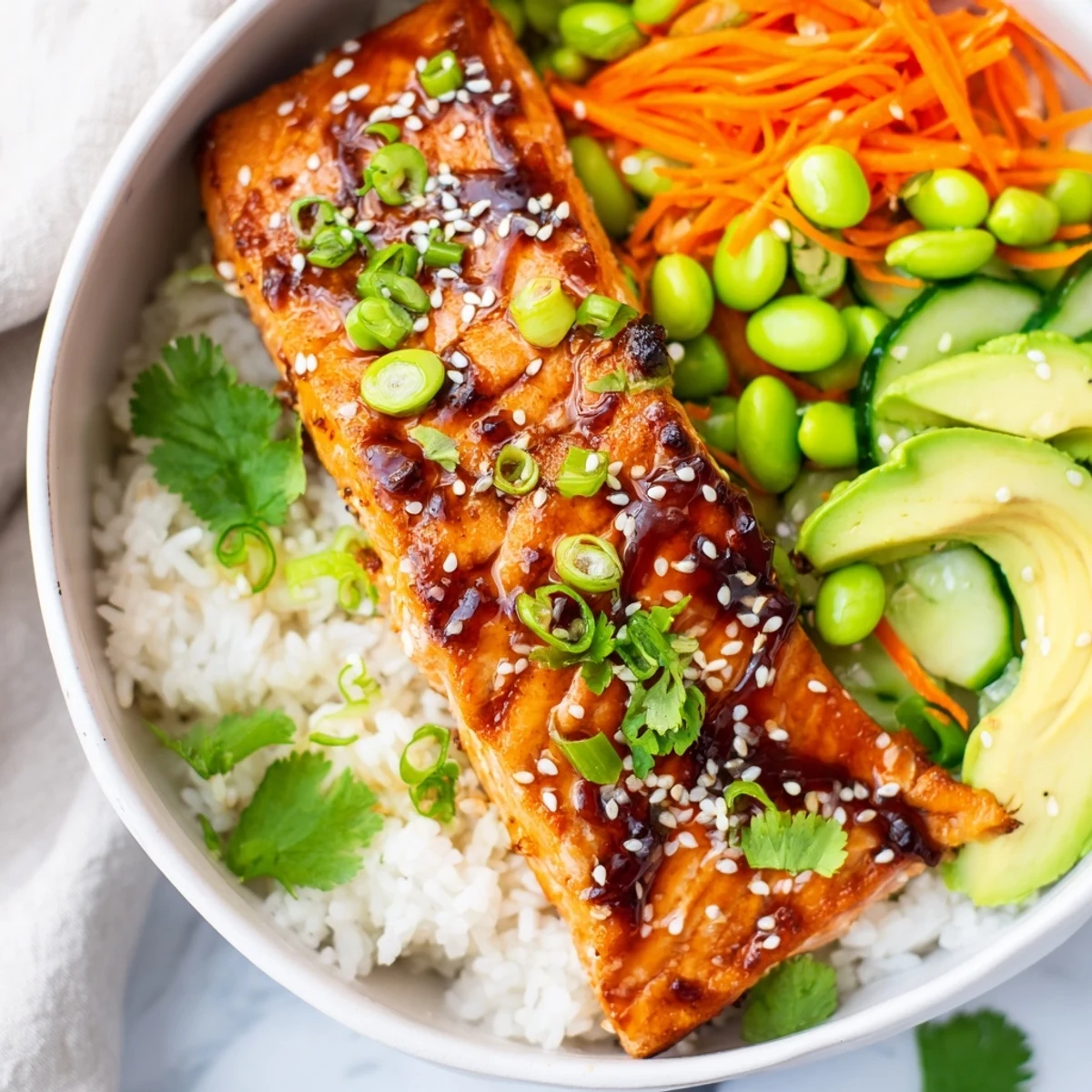 Golden honey glazed salmon bowl with fluffy rice and colorful fresh vegetables