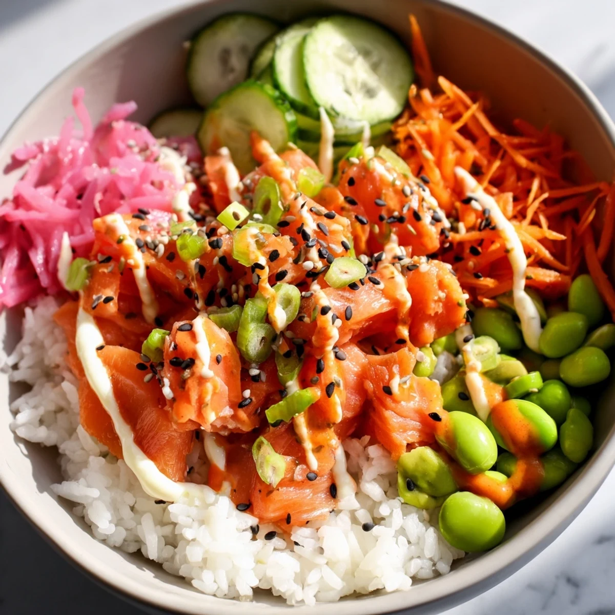 Golden baked salmon flaked over fluffy rice with crisp cucumber, avocado, and spicy sriracha mayo drizzle