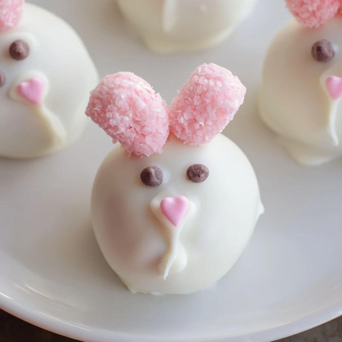 Adorable white chocolate Bunny Oreo Balls decorated with cute faces and fluffy marshmallow tails