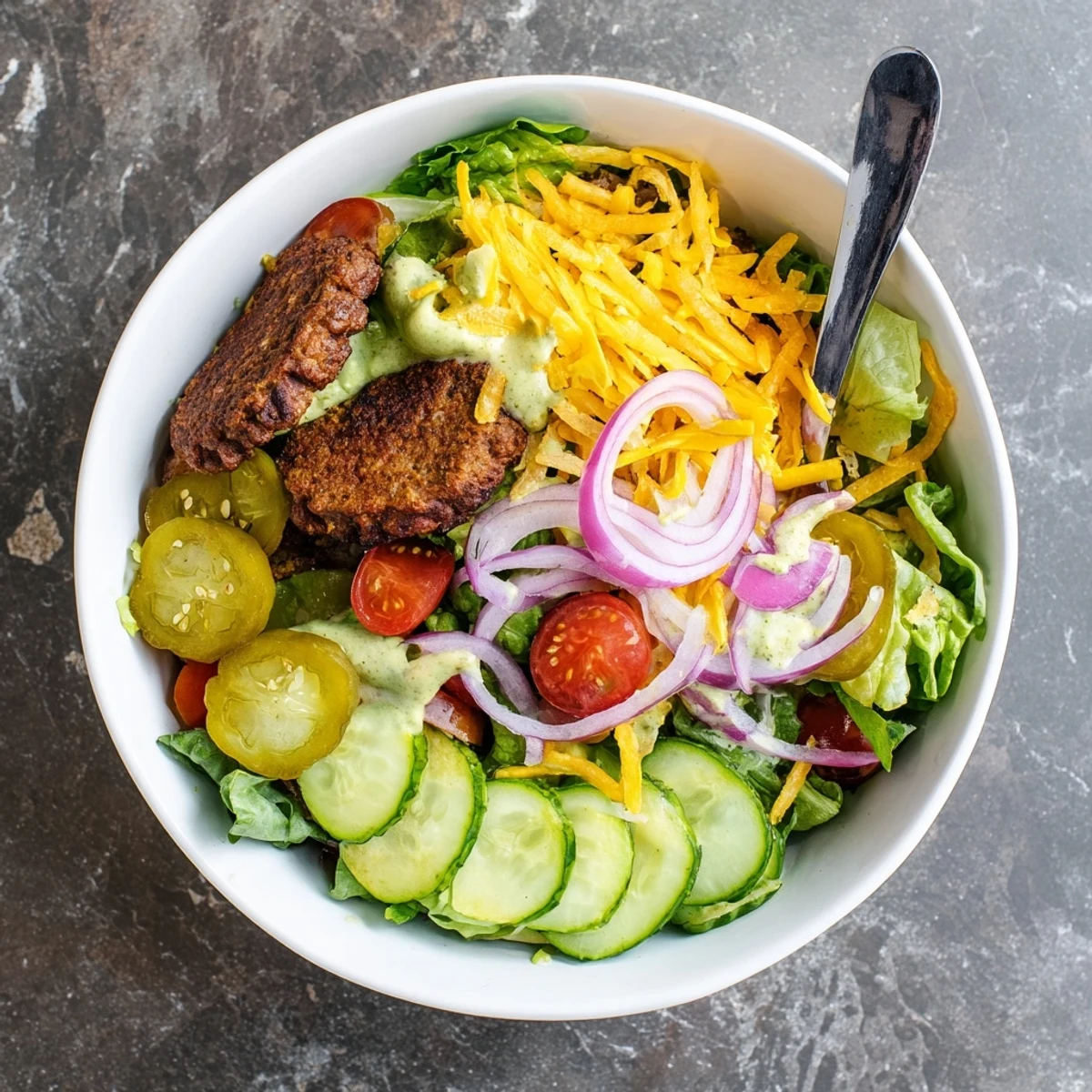 Golden crispy smash burger patties served over fresh greens with tangy pickles and creamy sauce