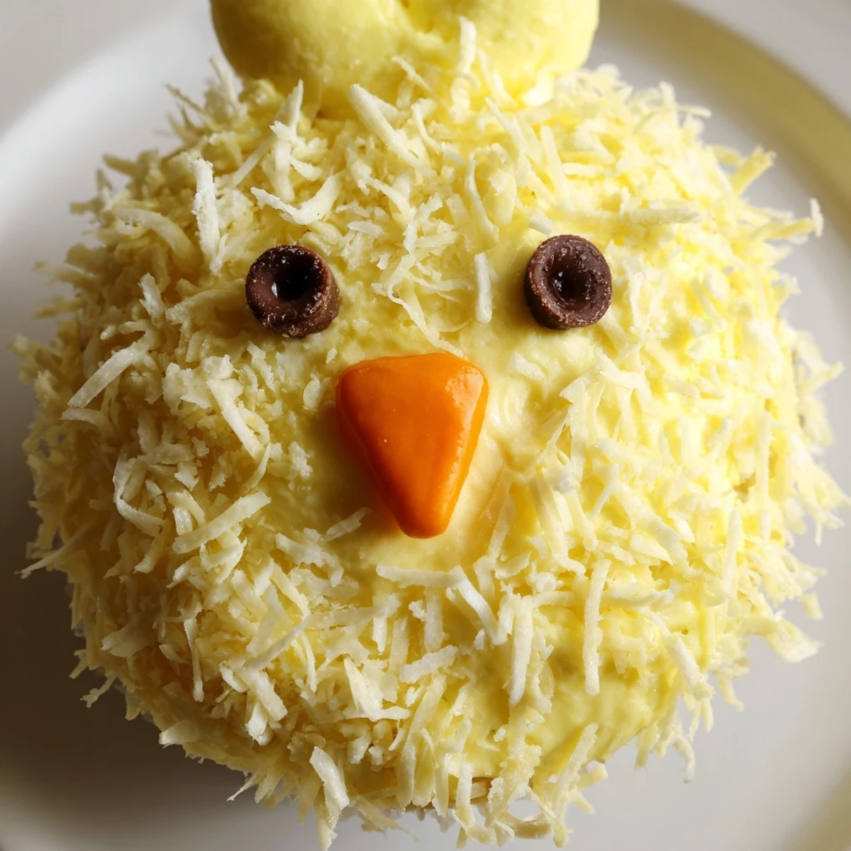 Adorable Easter Chick Cupcakes with fluffy yellow frosting and sweet candy faces on display