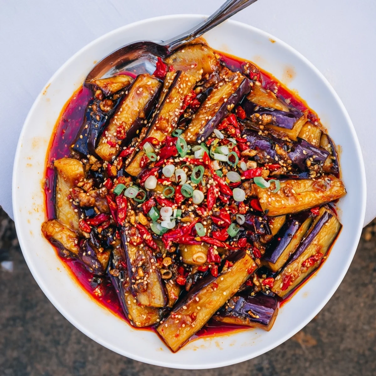 Sichuan Style Braised Aubergines spicy, glossy stir-fry served steaming alongside jasmine rice