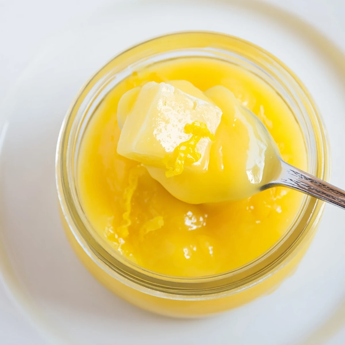 Lemon Curd Recipe cooling in sterilized jar; glossy, bright yellow spread