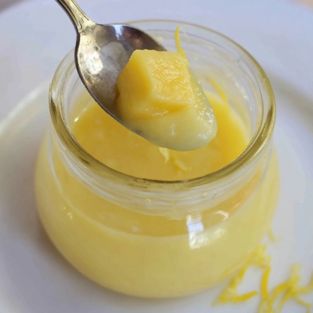 Warm, whisked Lemon Curd Recipe in double boiler showing silky sheen