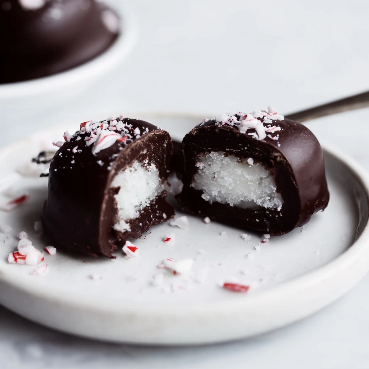 Homemade Peppermint Patties chilled and stacked, perfect after dinner minty treats.