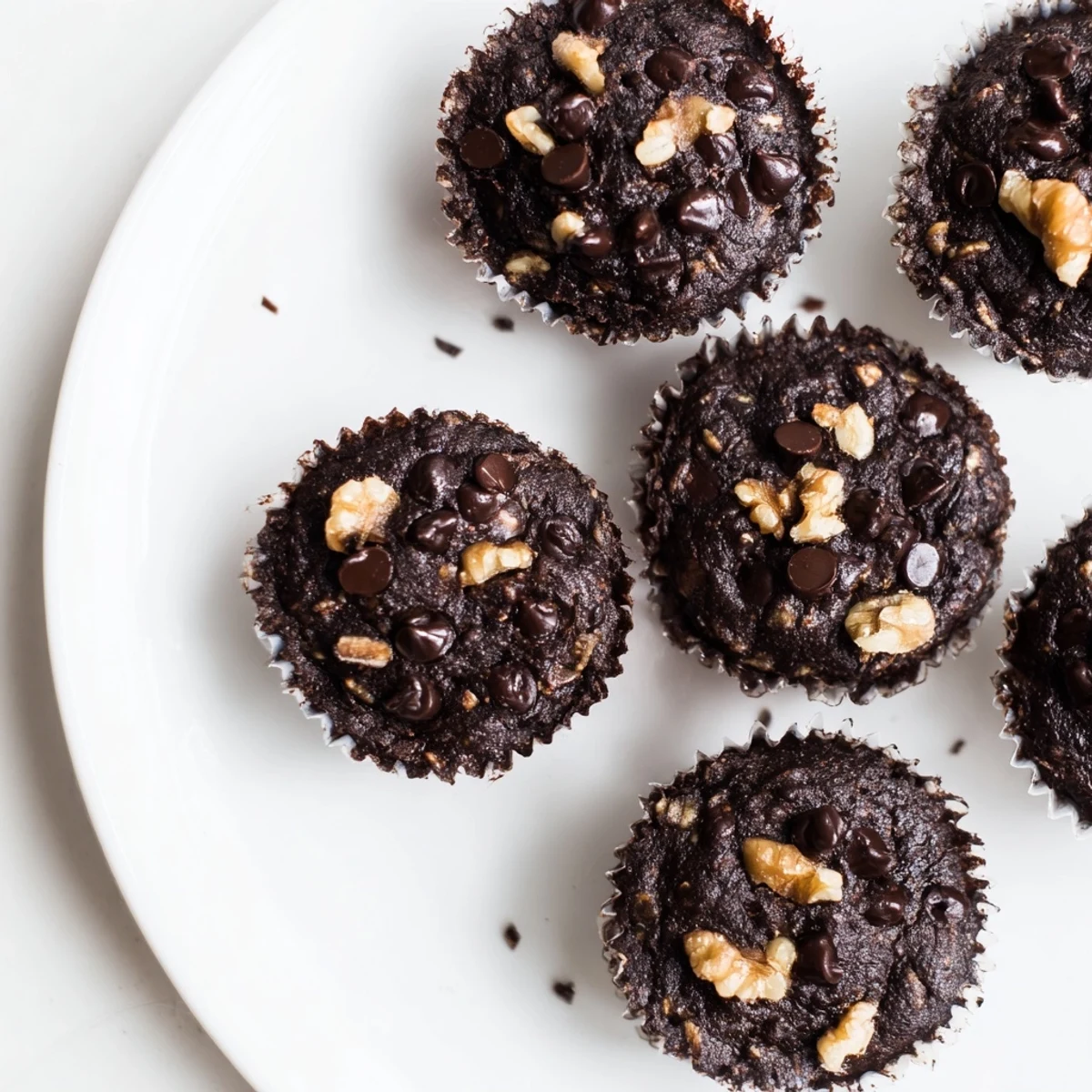 Fudgy dark chocolate oatmeal cups cooling on a wire rack with a sprinkle of sea salt