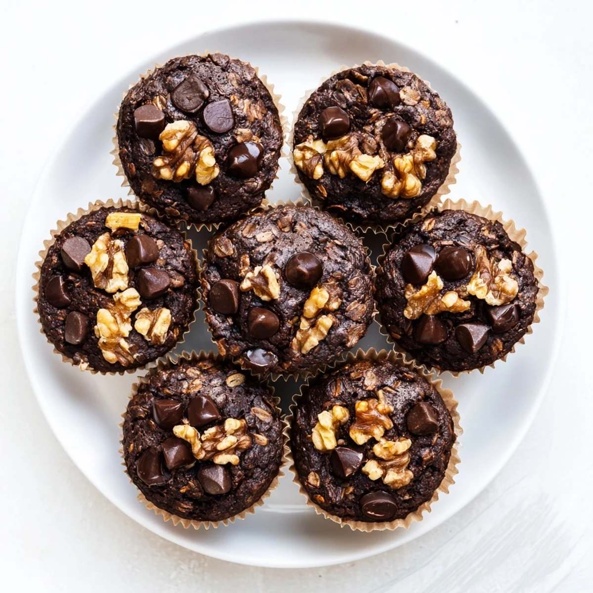 Rich cocoa dark chocolate oatmeal cups with visible rolled oats and dark chocolate chunks throughout