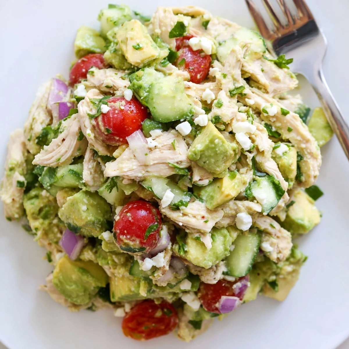 Creamy Avocado Chicken Salad with diced tomatoes and lime, picnic-ready.