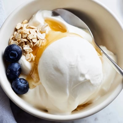 Thick tangy homemade yogurt drizzled with golden honey and crunchy granola